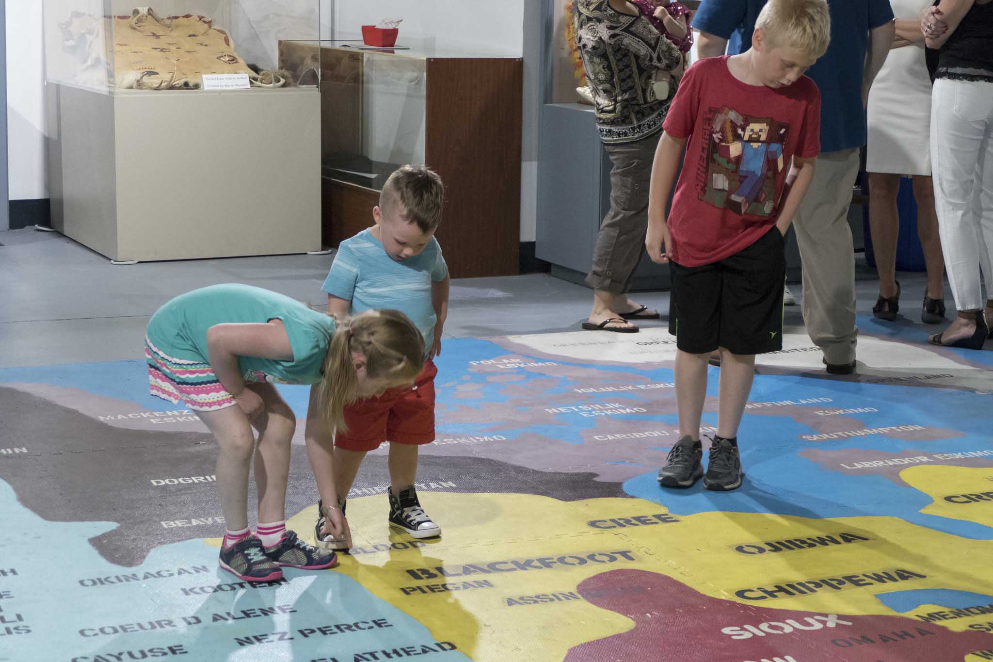 Kids exploring gallery floor map