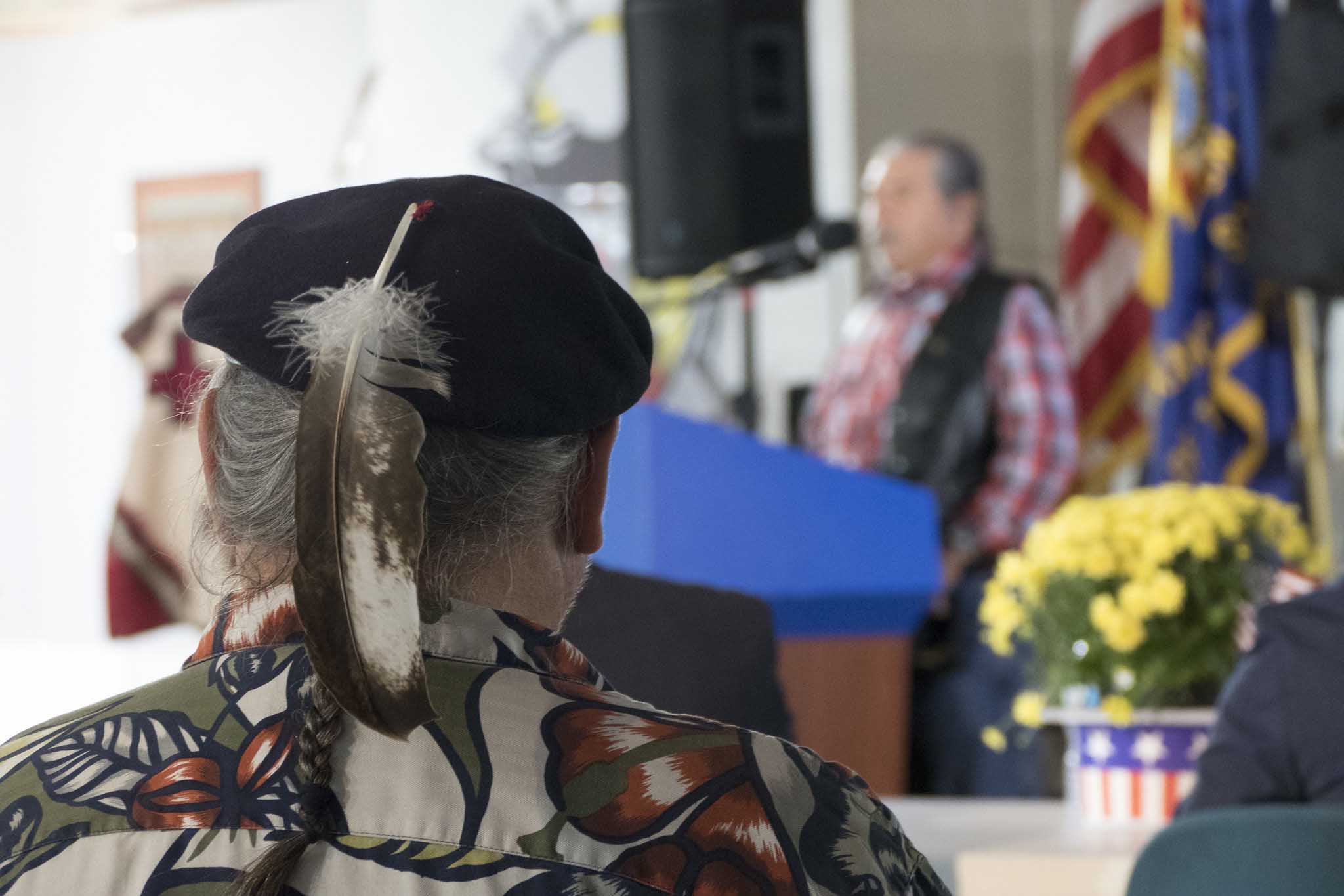 Veteran listening to speaker at gallery